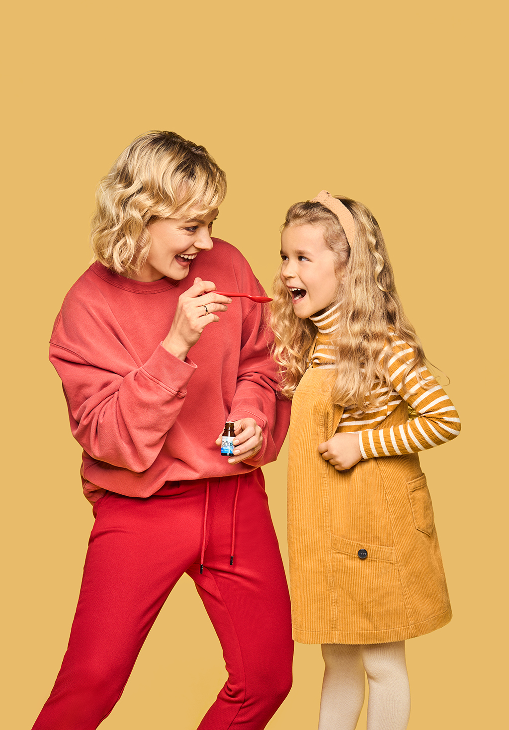 mother givving her daughter a medicine